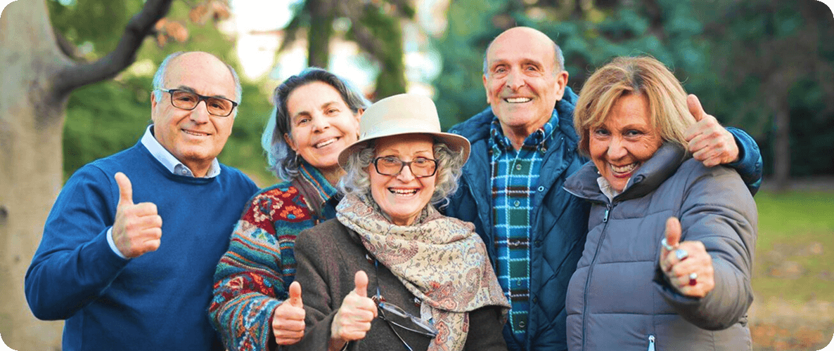 A family spending time outdoors with an older relative