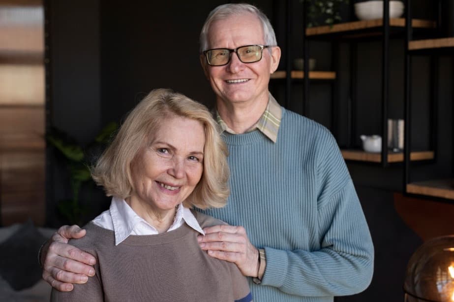 An older couple smiling together at home